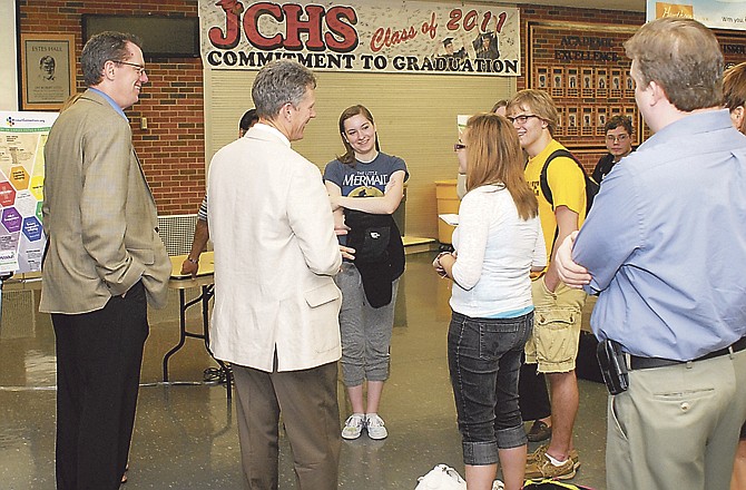 David Luther, director of school-community relations, and Myron Graber, director of secondary education, discuss options with students and parents at an open house public forum held at Jefferson City High School.


