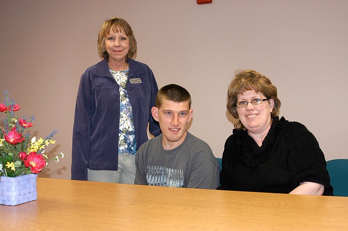 Sam Denker, center, has been coping with autism for 28 years, with the help of his mother barb, right. At the left is SB40 Board Service Coordinator Supervisor Jane Blank. 