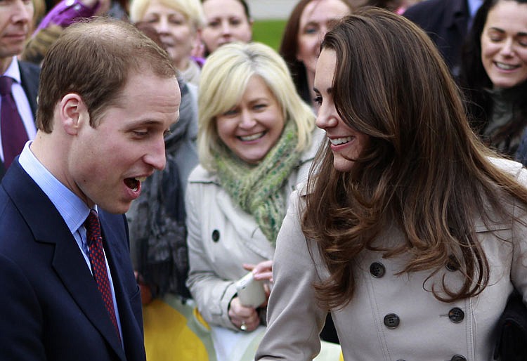 FILE - In this Tuesday, March 8, 2011 file photo, Britain's Prince William and Kate Middleton prepare to flip pancake at a display by the charity Northern Ireland Cancer Fund for Children outside the City Hall in Belfast, Northern Ireland. Prince William might seem like someone who has it all: royal status, a charming fiancee, good health, and an easy touch with his future subjects. But there is something he lacks: A full head of hair. Casual observers who have not paid much attention to the future king during the years before his engagement to Kate Middleton have been surprised by the extent of his hair loss, particularly since younger brother Prince Harry still sports a luxuriant supply of tousled red hair.