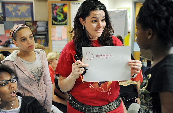 Jeni DeFeo helps a sixth-grader choose a word for a "stump your classmates" game during English class at Thomas Jefferson Middle School.