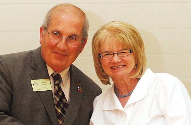 Mary Ellen DeSutter, a fifth-grade teacher at Thorpe Gordon, receives her 35-year pin from Jefferson City school board president Alan Mudd at the 2011 Teacher Appreciation Banquet on Thursday at Lewis and Clark Middle School.