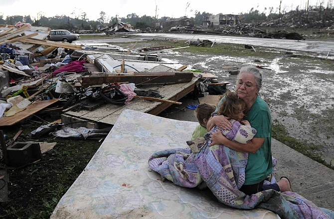 Faye Hyde, right, sits on a mattress in what was her yard as she comforts her granddaughter Sierra Goldsmith, 2, in Conord Ala. Wednesday, April 27, 2011. Their home was completely destroyed. A wave of tornado-spawning storms strafed the South on Wednesday, splintering buildings across hard-hit Alabama and killing hundreds of people in several states. 