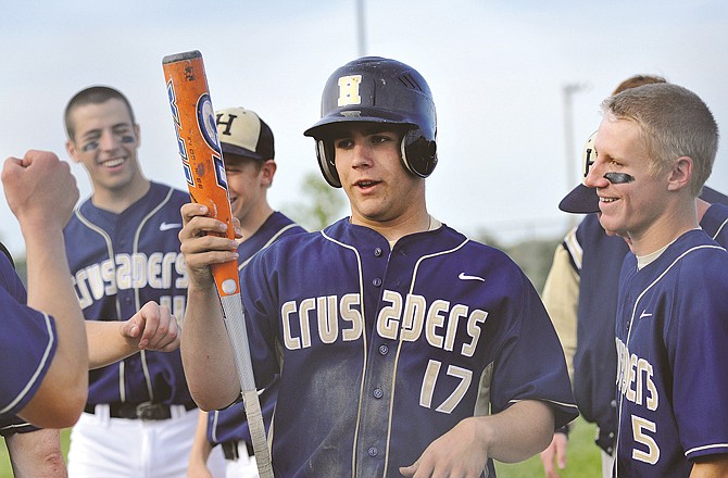 
Zach Backes (17) of Helias celebrates after scoring a run during Friday's game against Hannibal at the American Legion Post 5 Sports Complex. To view this and other photographs, please visit www.newstribune.com/photos.