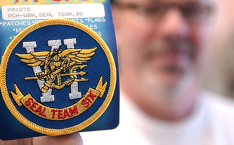 Outdoor Army-Navy store owner Bill Hyland displays the U.S. Navy Seal Team Six patch available at his store on Main Avenue in Ashtabula, Ohio. Seal Team Six carried out the mission to kill Osama bin Laden in Pakistan. "It was great news," Hyland said. "Like the FBI, we always get our man." Hyland did not realize he had the Seal Team Six patch and pin in stock until it was pointed out to him by a customer.