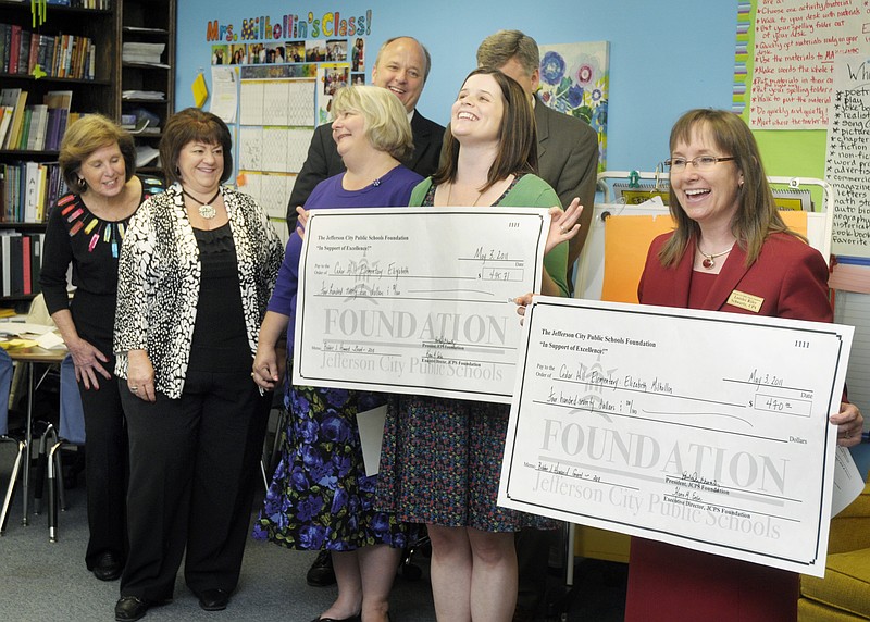 
Elizabeth Milhollin, second from right, was the recipient Tuesday of two grant checks presented to her by Lorelei Schwartz, at right, of the Jefferson City Public Schools Foundation.