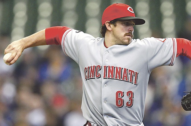 Reds pitcher Sam LeCure delivers a pitch during a game last month against the Brewers in Milwaukee. Reds manager Dusty Baker plans to move LeCure back into the bullpen this week. 