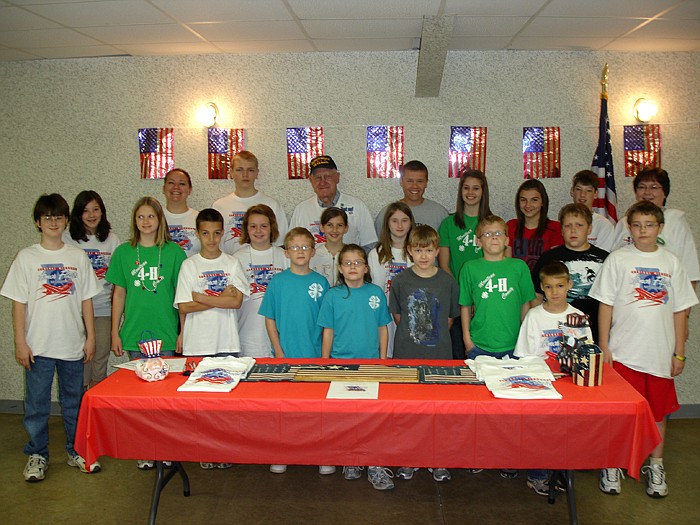 Norman Nivens, center, who the Eager Eagles 4-H Club sponsored for an Honor Flight, with members of the Eager Eagles.