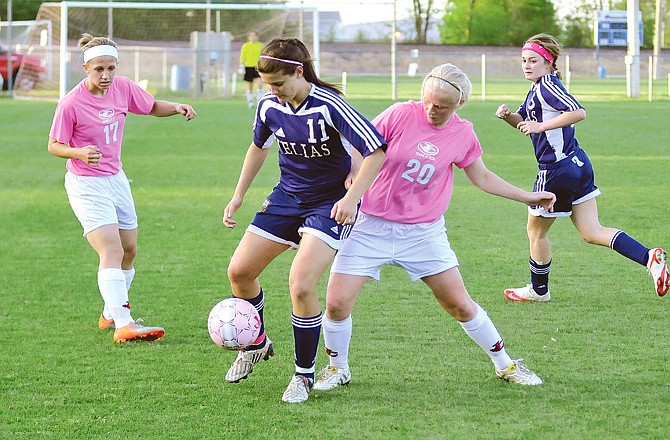 Kaitlin Brauner (11) of Helias and Corrine Mullarkey (20) of Jefferson City battle for the ball during Wednesday's crosstown showdown at the 179 Soccer Park.