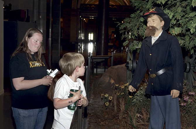 
Nicole Buschman, left, looks on as her son, Elijah Buschman, talks to a Civil War statue as the family visited the Capitol last Friday. 