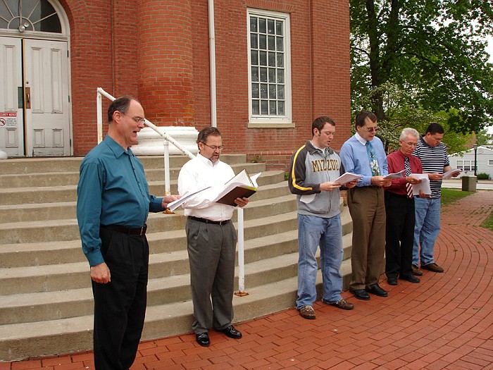 Reverend Tim Burgher, minister of music at First Baptist Church, California, leads in "A Mighty Fortress is our God" during the National Day of Prayer event held at the Moniteau County Courthouse Thursday, May 5. Other pastors present; from left, are Burgher, Frank Hensley, New Life Christian Church, California, Eddie Schoeneberg, Main Street Baptist Church, California, Dr. Peter Kurowski, St. Paul's Lutheran Church, Glen Golden, High Point Baptist Church, and Thomas Medlin, New Beginnings Family Worship Center, Califonria.