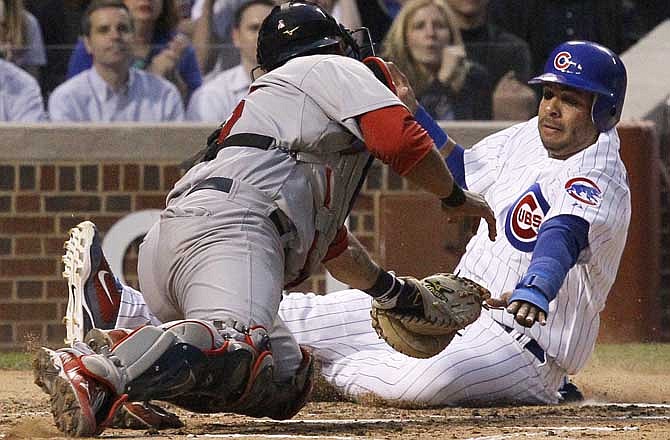 St. Louis Cardinals catcher Gerald Laird, left, tags Chicago Cubs' Aramis Ramirez out at home off a throw by center fielder Colby Rasmus during the second inning of a baseball game Wednesday, May 11, 2011 in Chicago. 