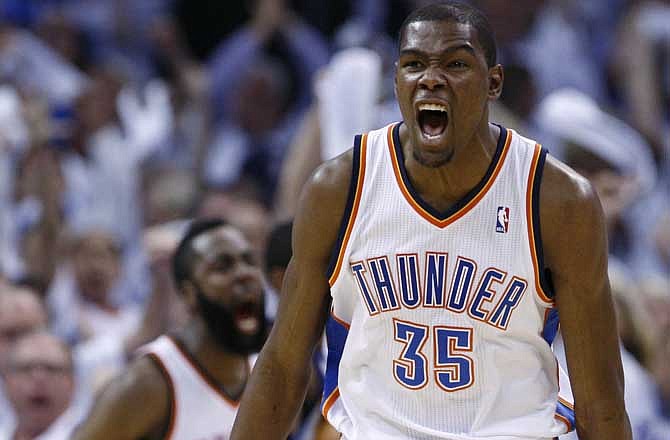 Oklahoma City Thunder forward Kevin Durant, right, reacts to a dunk by teammate James Harden, left, in the second quarter of Game 5 of a second-round NBA basketball playoff series against the Memphis Grizzlies in Oklahoma City, Wednessday, May 11, 2011. 