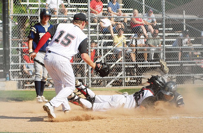 Jefferson City catcher Danny Eveler tries to tag out Holt's Conner Hales on a play at the plate during the second inning of Thursday's game at Vivion Field. Hales was safe on the play.