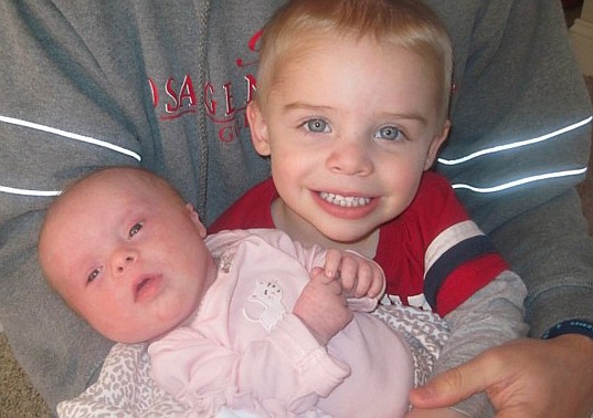 Maverick Manselle holds his little sister, Augusta Manselle. Augusta was born with Down syndrome, and her family is working to raise money and awareness for the disease.