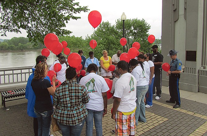Family and friends of Robert Nichols release balloons Friday afternoon at Rotary Centennial Park to honor his memory. It's been one year since Nichols was last seen going over the side of the northbound Missouri River Bridge.