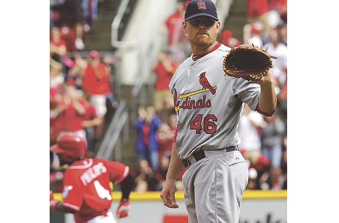 St. Louis Cardinals starting pitcher Kyle McClellan (46) waits for the ball after giving up a solo home run to Cincinnati Reds' Brandon Phillips (4) in the second inning of a baseball game, Saturday, May 14, 2011 in Cincinnati.