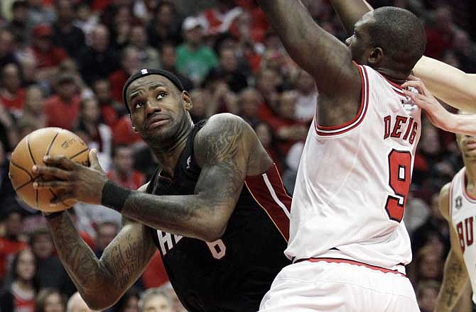 Miami Heat's LeBron James, left, looks to the basket as Chicago Bulls' Luol Deng defends during the second quarter in Game 1 of the NBA Eastern Conference finals basketball series Sunday, May 15, 2011 in Chicago. 