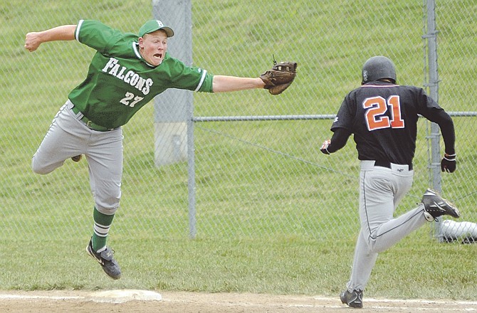 
Falcons first baseman Adam Forck hangs on to a wild throw and tags out Owensville's Terry Adams in the top of the fourth inning of Saturday's game at the Falcon Athletic Complex in Wardsville. 