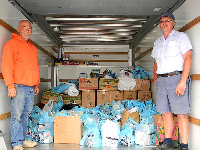 Jay Starr, a volunteer with the California Food Bank, and Dennis Scheidt, a carrier with the California Post Office, with food collected by the California Post Office, rural carriers and volunteers and was donated to the California Food Bank.