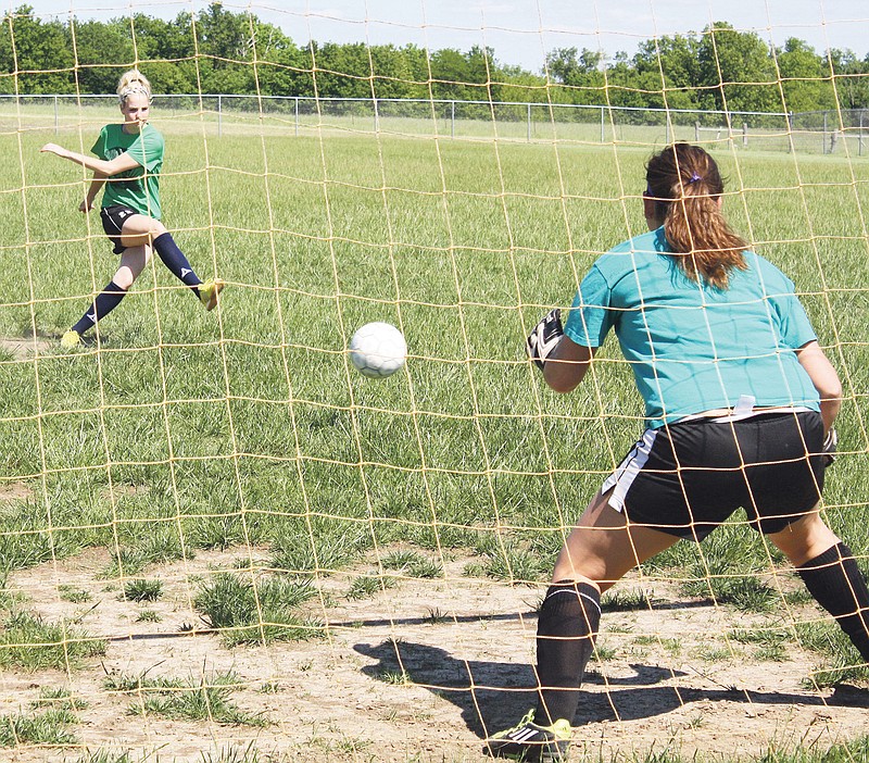Fulton senior midfielder Kara Henry tries to steer a shot past sophomore goalkeeper Billie Klutts during a penalty-kick drill in Monday's practice at the high school sports complex. The No. 2 seed Lady Hornets clash with top-seeded Jefferson City Helias for the Class 2, District 10 title tonight in Boonville.