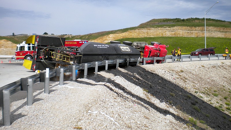 A one-vehicle accident involving a semi-truck pulling a tanker-type trailer full of "Rhino Sealer" asphalt seal resulted in 4,000 gallons spill into a creek that acts as a tributary of the Osage River.