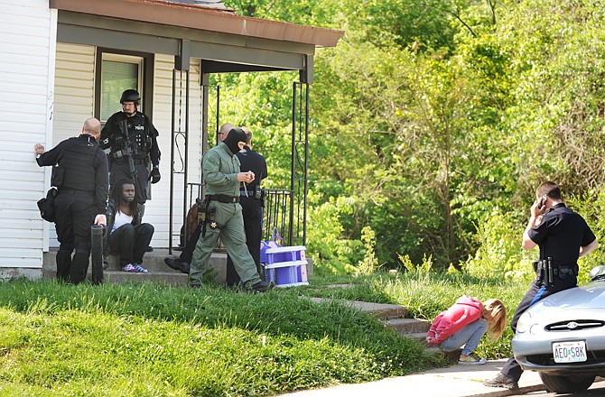 Members of the MUSTANG Task Force served warrants Wednesday on two residences on Olive Street.