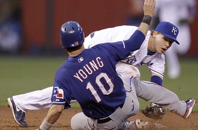 Kansas City Royals second baseman Chris Getz tries to keep control of the ball after forcing out Texas Rangers' Michael Young (10) at second on a ball hit by Adrian Beltre, who was safe at first during the third inning of a baseball game Wednesday, May 18, 2011, in Kansas City, Mo. 