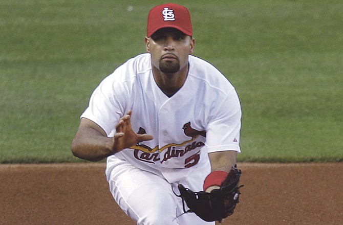 St. Louis Cardinals third baseman Albert Pujols handles a bouncing grounder hit by Philadelphia Phillies' John Mayberry Jr. during the second inning of a baseball game Monday, May 16, 2011, in St. Louis. 