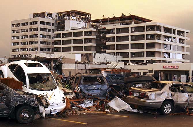 Destroyed vehicles are piled on top of one another in the parking lot of the Joplin Regional Medical Center in Joplin, Mo., Sunday, May 22, 2011. A large tornado moved through much of the city, damaging the hospital and hundreds of homes and businesses.