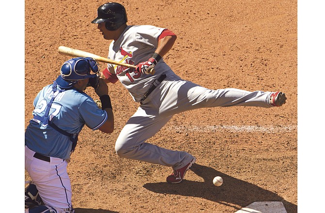 St. Louis Cardinals' Gerald Laird falls back while Kansas City Royals catcher Brayan Pena tries to catch the ball after Laird was hit by a pitch thrown by relief pitcher Louis Coleman during the 10th inning of a baseball game Sunday, May 22, 2011, in Kansas City, Mo. The Cardinals won the game 9-8 in 10 innings. 