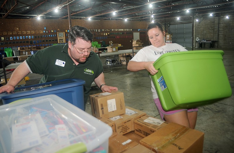 Tony Giuliani and Jennifer Heard load boxes onto a pallet as they collect supplies for Joplin tornado victims Tuesday at the fairgrounds. Collections will continue from 9 a.m. until 7 p.m. today. Guiliani said they hope to ship the supplies on Thursday morning. 