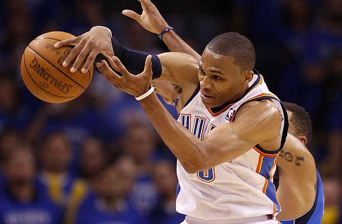 Oklahoma City Thunder's Russell Westbrook and Dallas Mavericks' Shawn Marion, rear, compete for a loose ball in the first half of Game 4 of the NBA Western Conference finals basketball series Monday, May 23, 2011, in Oklahoma City.