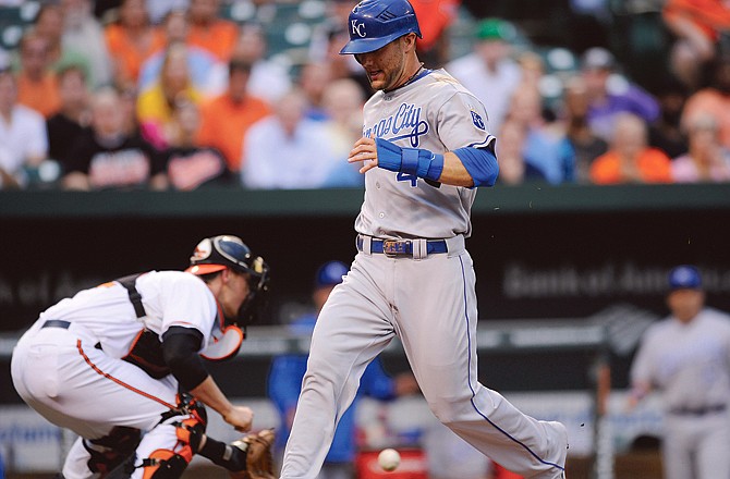 Alex Gordon of the Royals scores on a single by Jeff Francoeur during the first inning of Tuesday's game in Baltimore as Orioles catcher Matt Wieters (background) waits for the late throw.