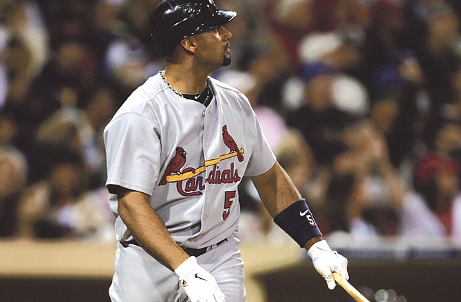 St. Louis Cardinals' Albert Pujols watches his sixth-inning home run against the San Diego Padres in a baseball game Monday, May 23, 2011 in San Diego. 
