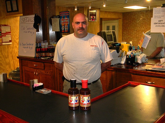 Jason Morris, co-owner and one half of Moose Bros BBQ, located at 13211 Railroad Avenue, Russellville, with their spicy and original barbecue sauces.