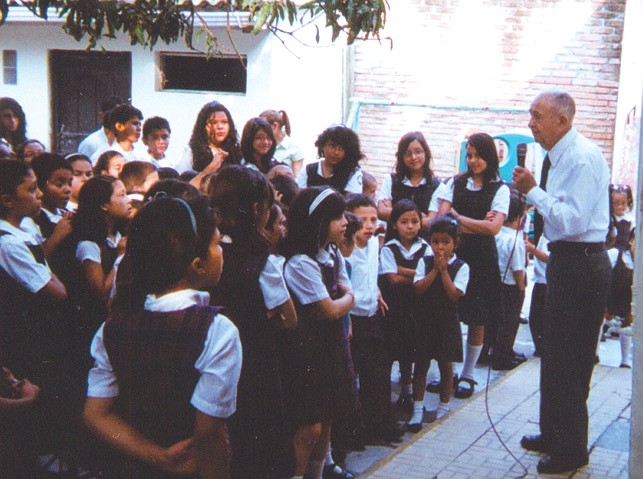 Bishop Bill Rogers preaches to school children during his mission trip last week in Honduras.