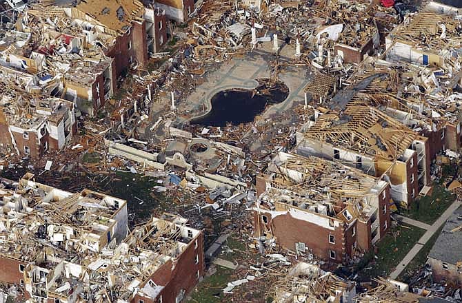 A destroyed apartment complex is seen in Joplin, Mo. Tuesday, May 24, 2011. A large tornado moved through much of the city Sunday, damaging a hospital and hundreds of homes and businesses. 