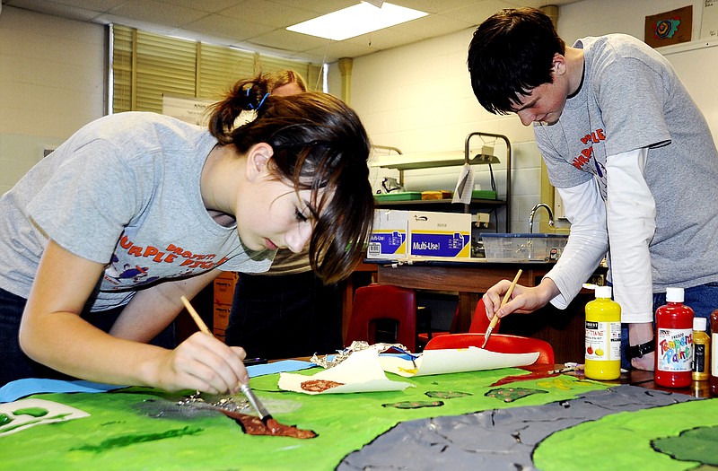 Madelyn Simpson and Michael Ginther paint a backdrop for a Destination Imagination project. The local team will compete at the national competition this weekend.