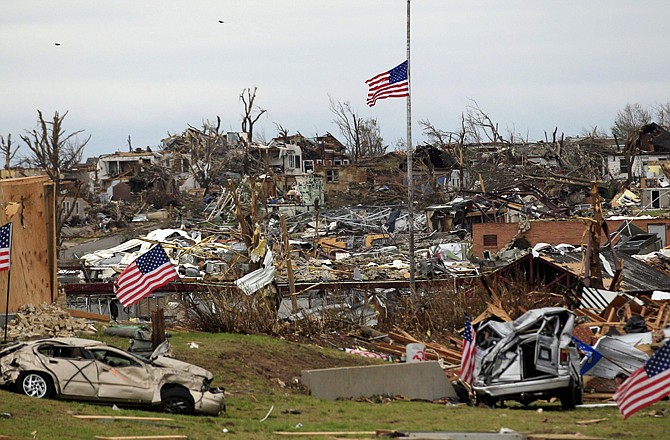 A flag files at half staff over devastated Joplin High School. An EF-5 tornado tore through much of the city Sunday, damaging a hospital and hundreds of homes and businesses and killing at least 132 people.