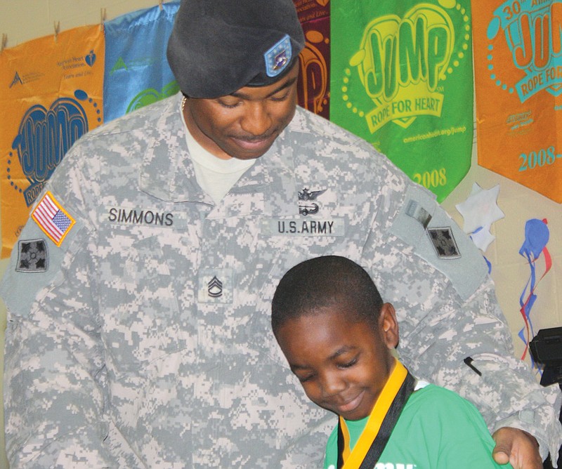 Bush Elementary kindergartner Courtland Simmons savors the reunion with his father, Sgt. 1st Class Courtney Simmons. Courtney Simmons surprised Courtland - who did not know that his father was coming home from a one-year deployment in Afghanistan - by presenting him with his perfect attendance award during the school's annual awards assembly.