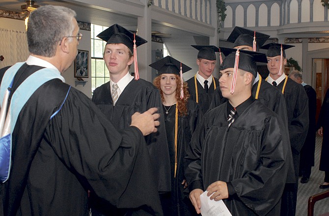 
Executive Director, John Engelbrecht, directs the graduates as they prepare to begin the Service of Praise and Commencement Exercises for their 2011 graduation class, Saturday at Immanuel Lutheran Church on Tanner Bridge Road.