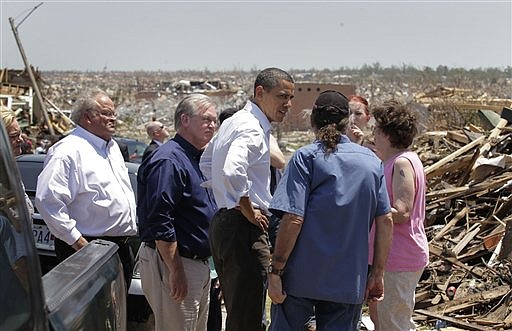President Barack Obama, center right, views damage from the tornado that devastated Joplin, Mo., Sunday, May 29, 2011.