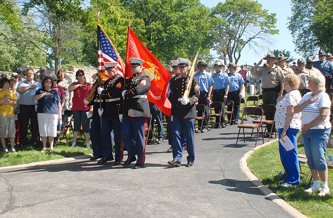 The crowd salutes as the posting of colors is performed by the S.F. Gearhart Detachment Marine Corps League during the 2011 Memorial Day Program held at the National Cemetery on Monday morning.