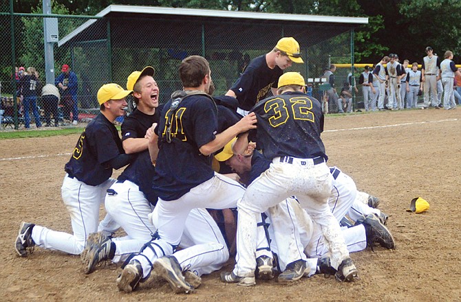 The St. Elizabeth Hornets celebrate at the end of their 8-4 win in eight innings over the Northeast: Cairo Bearcats last Friday in St. Elizabeth.