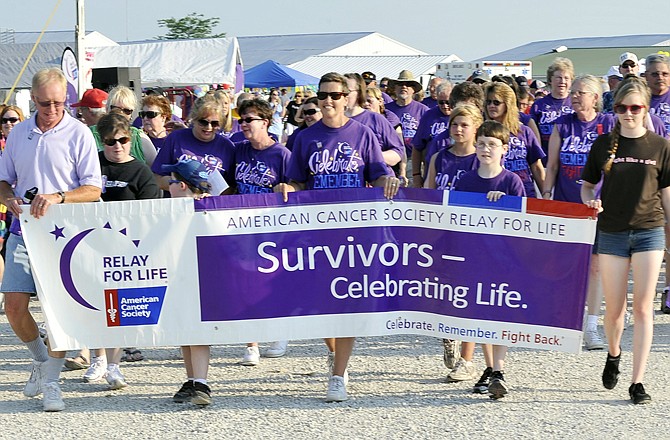 Cancer survivors take the first lap at the Cole County Relay for Life during the opening ceremony Friday evening, June 3, 2011 at the Jefferson City Jaycees Fairgrounds.