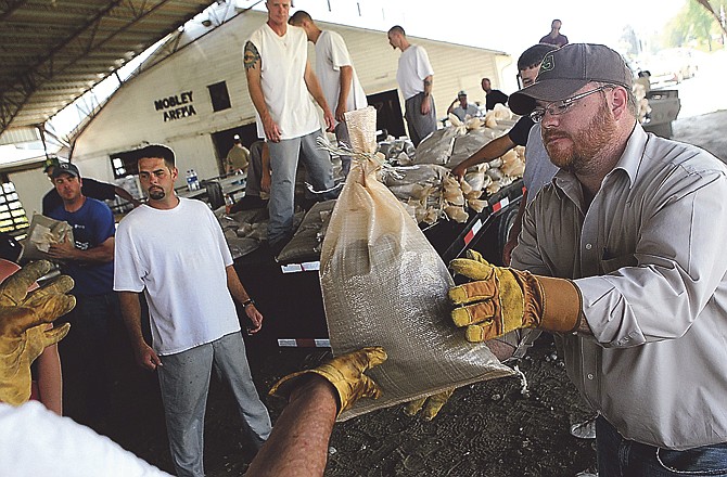 John Thompson joined a group of volunteers and prisoners loading sandbags onto trailers Friday, June 3, 2011 in Rock Port, Mo. as the area prepares for the worst flooding seen on the Missouri River since 1993. 