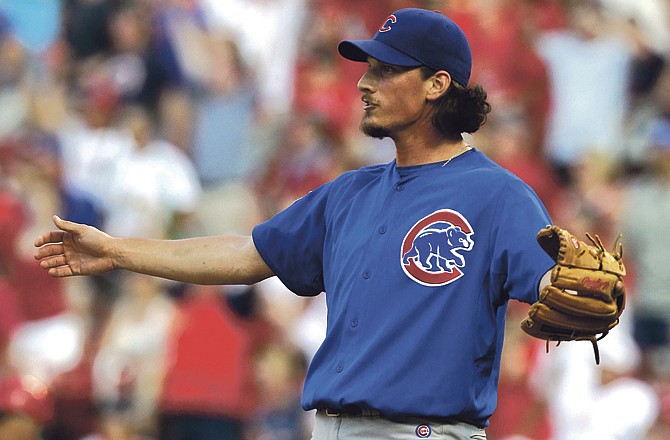 Chicago Cubs relief pitcher Jeff Samardzija reacts as he watches a walkoff home run by St. Louis Cardinals' Albert Pujols sail out of the park during the 12th inning of a baseball game on Saturday, June 4, 2011, in St. Louis. The Cardinals won 5-4.