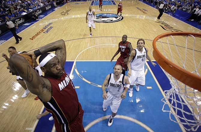 Miami Heat's LeBron James dunks during the second half of Game 3 of the NBA Finals basketball game against the Dallas Mavericks Sunday, June 5, 2011, in Dallas. 