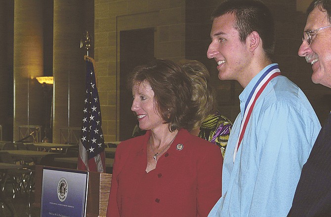 Congresswoman Vicky Hartzler stands with Zachary Williams and Mike Esser, president of the Missouri Congressional Awards Council, after Williams received his medal. 