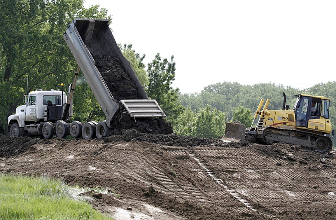 Work continues on a levee in Dakota Dunes, S.D. on Saturday. The U.S. Army Corps of Engineers says the Missouri River has surpassed flood stage in the South Dakota capital of Pierre and its sister city, Fort Pierre.